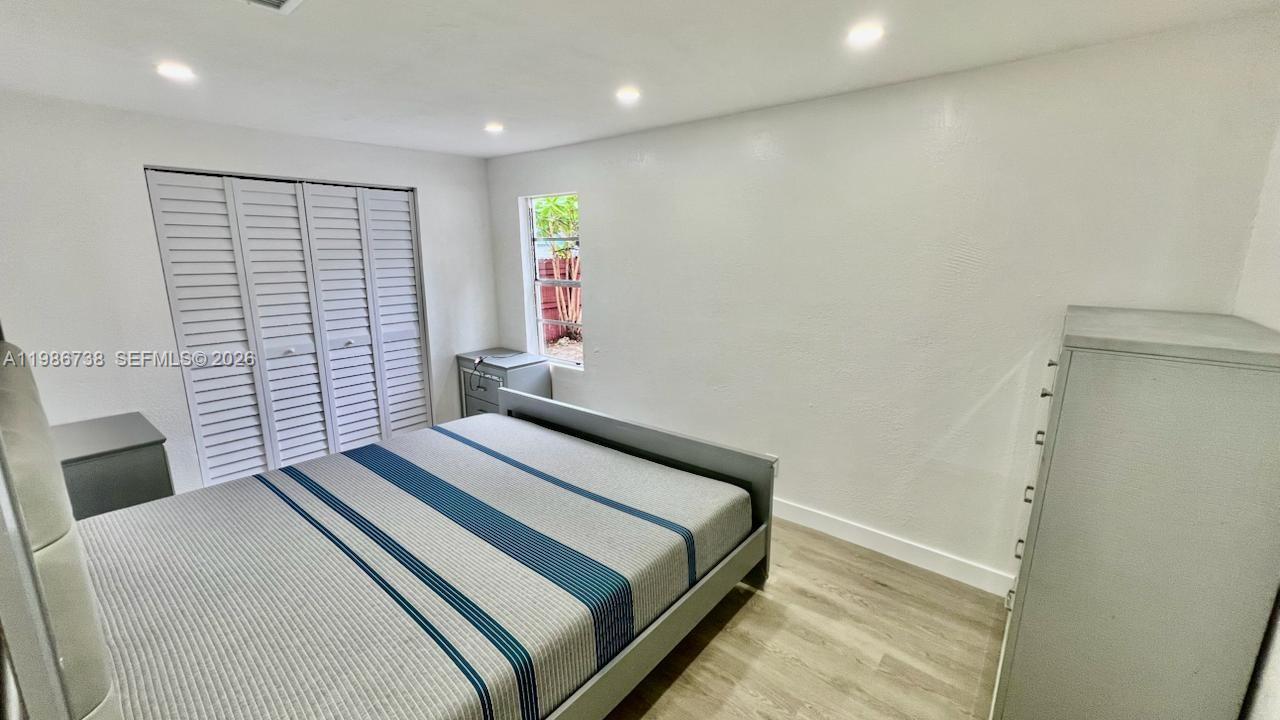 48 Southwest 14th Street Dania Beach, FL 33004 - Photo 7 of 13 a bedroom with a bed and a window