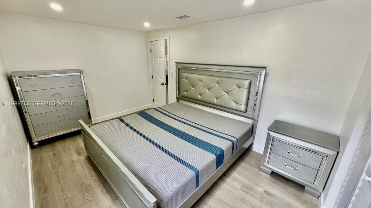 48 Southwest 14th Street Dania Beach, FL 33004 - Photo 8 of 13 a hallway with a bed