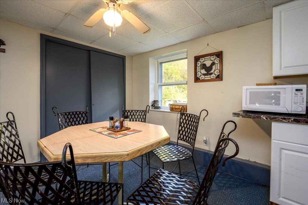 2641 Tower Road Jefferson, OH 44047 - Photo 12 of 35 Carpeted dining room featuring a drop ceiling and ceiling fan