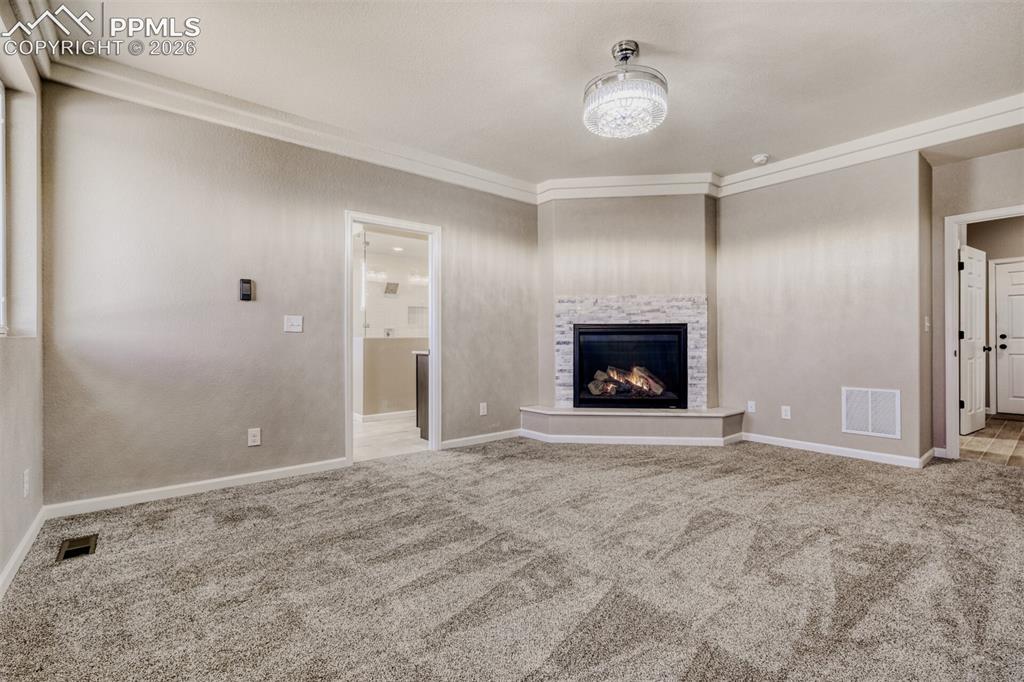 13680 Woodlake Road Elbert, CO 80106 - Photo 21 of 47 Primary Bedroom with fireplace, massive closet, lux 5-piece bath