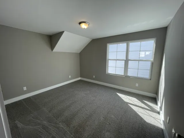 an empty room with a empty space and windows