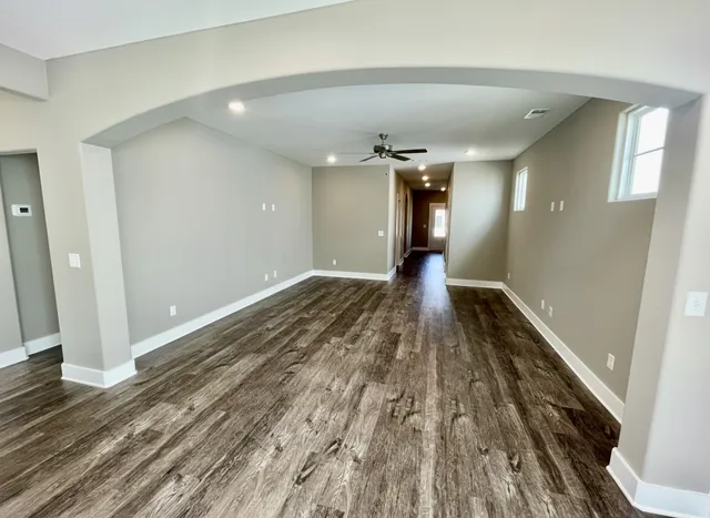 a view of a hallway with wooden floor