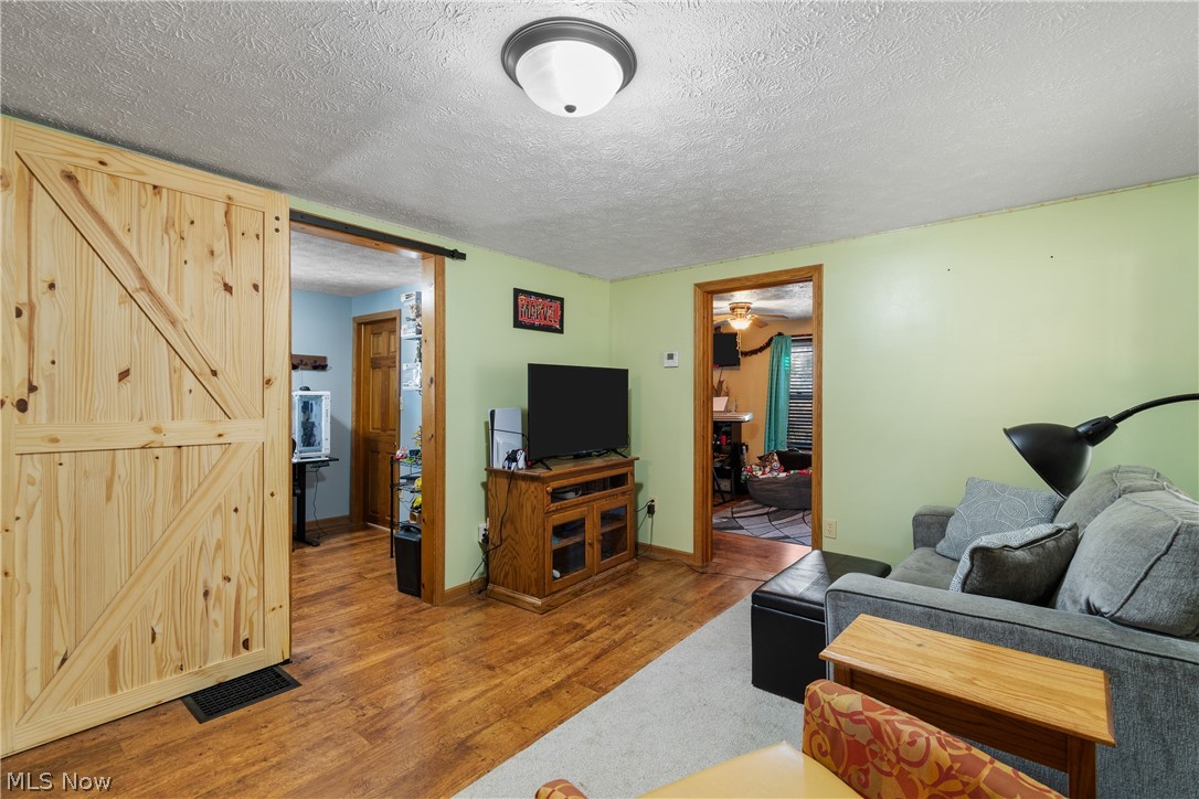 29395 Beitler Road Dennison, OH 44621 - Photo 8 of 33 Living room with a textured ceiling and light wood-style flooring