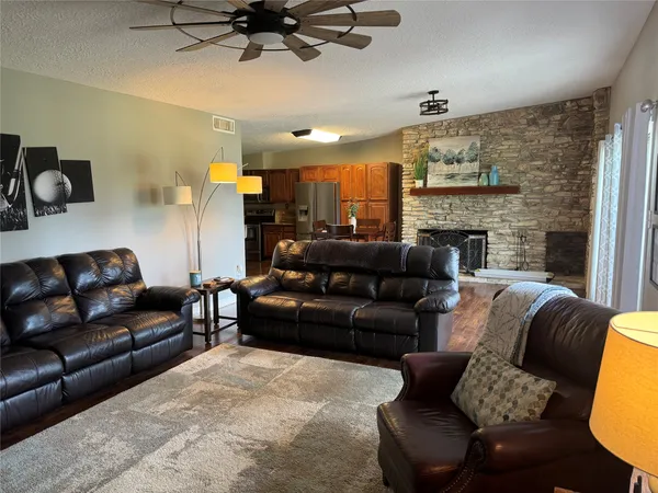 a living room with furniture and a fireplace