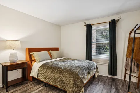 a bedroom with a bed and a window