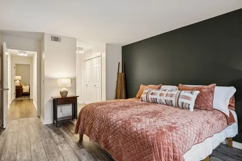 a bedroom with a bed and a table