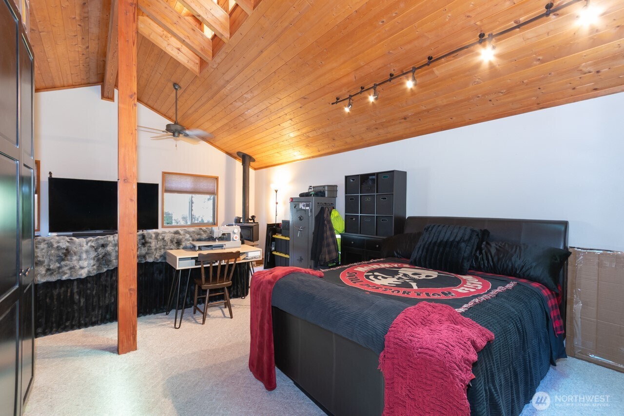 492 Walkabout Way Port Angeles, WA 98363 - Photo 36 of 40 a bedroom with a bed a flat screen tv and a table