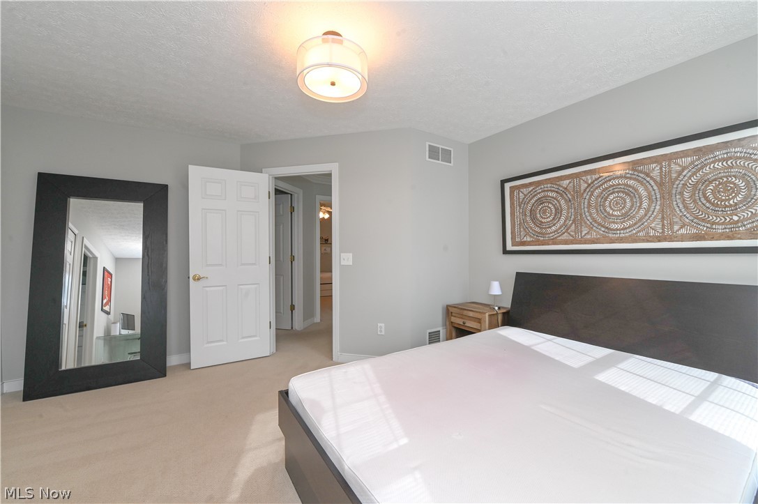 1688 Sheridan Road South Euclid, OH 44121 - Photo 17 of 48 Bedroom with light carpet and a textured ceiling