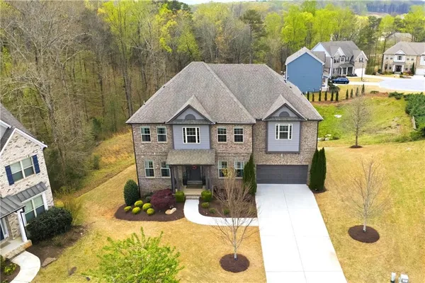 a view of a house with a yard and tree s