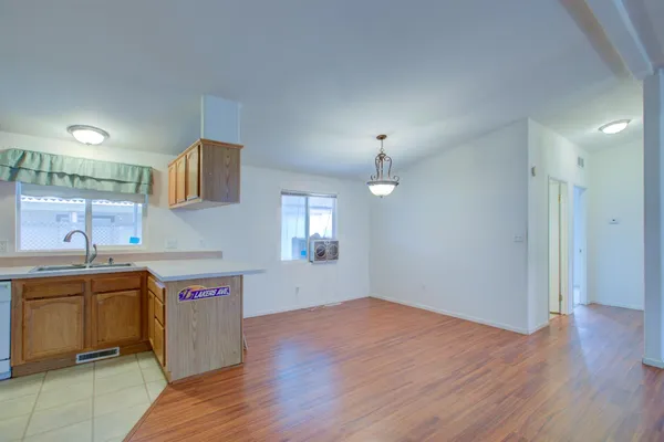 a view of a kitchen with a sink and wooden floor