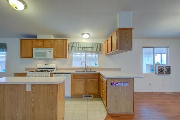 a kitchen with stainless steel appliances granite countertop a sink stove and cabinets