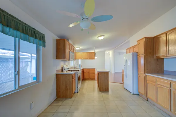 a kitchen with stainless steel appliances granite countertop a refrigerator and a stove top oven