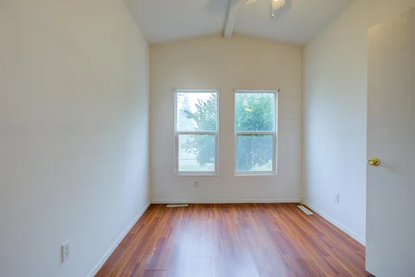 a view of a hallway with wooden floor