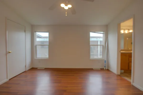 a view of an empty room and wooden floor