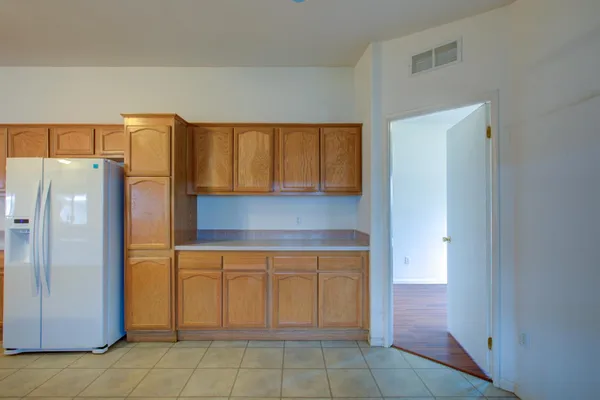 a kitchen with a refrigerator and cabinets