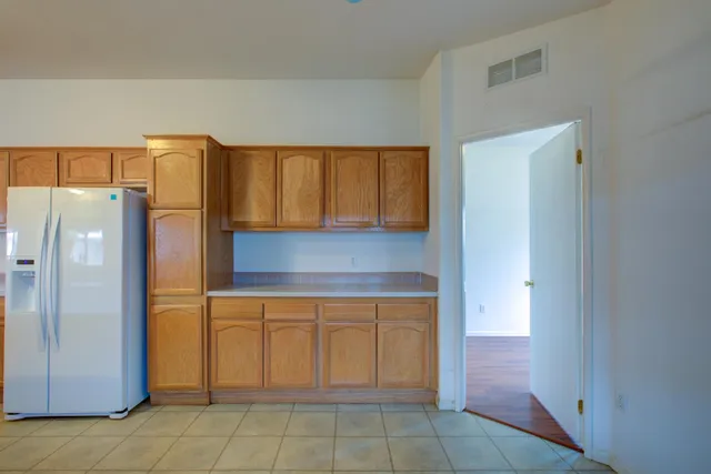a kitchen with a refrigerator and cabinets
