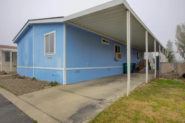 a view of a house with wooden fence