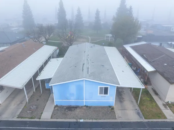 an aerial view of a residential houses with outdoor space and street view
