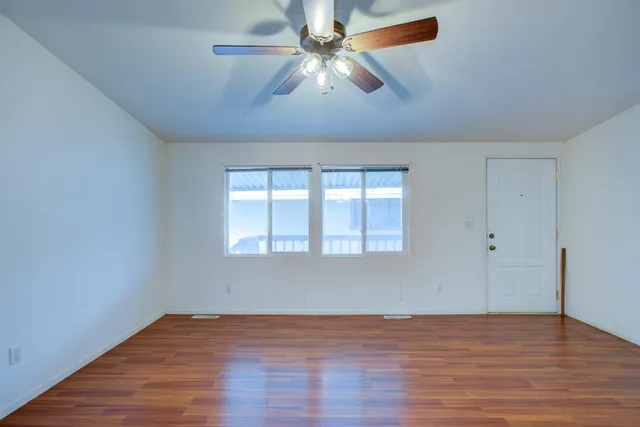 wooden floor in an empty room with a window