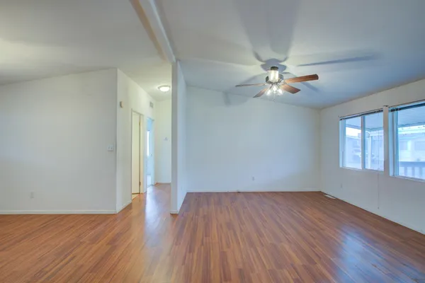 wooden floor in an empty room with a window