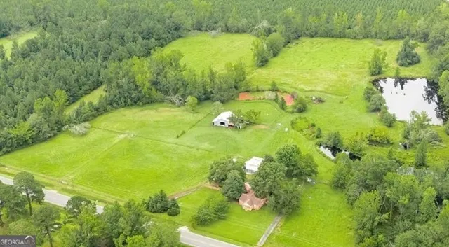 a backyard of a house with lots of green space and mountain view in back