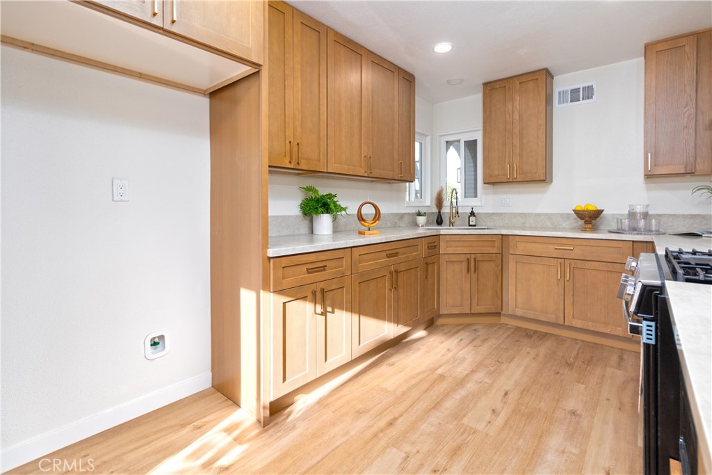 3306 Debbie Lane Riverside, CA 92501 - Photo 11 of 32 a kitchen with stainless steel appliances granite countertop a sink stove and cabinets