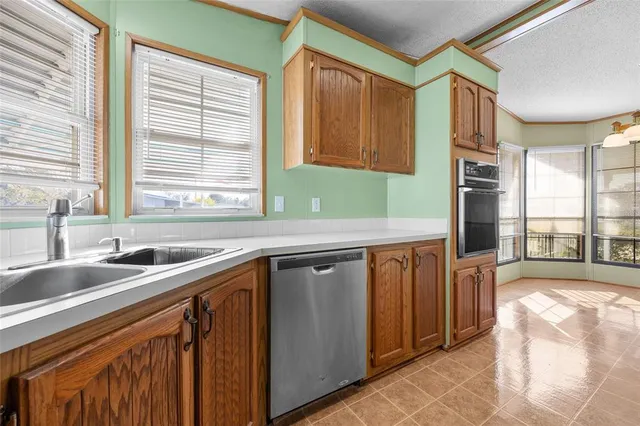a kitchen with stainless steel appliances granite countertop sink stove and cabinets