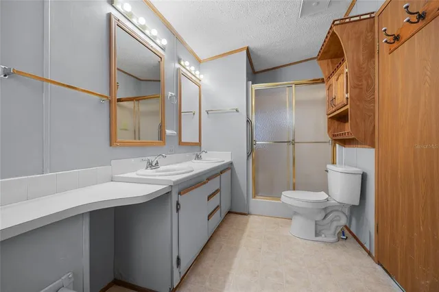 a bathroom with a toilet sink and shower