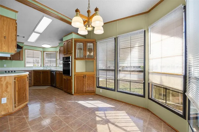 a view of a kitchen with a sink stainless steel appliances and cabinets