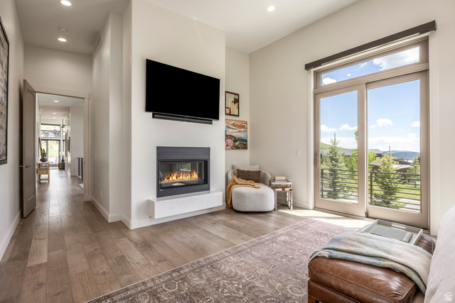 140 West Vista Road Kamas, UT 84036 - Photo 14 of 101 Built-in fireplace with hearth, wood-finish flooring, glass sliding doors, and recessed lighting