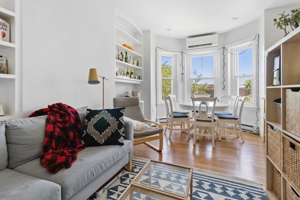 28 Beacon Street, Unit 3 Somerville, MA 02143 - Photo 1 of 11 a living room with furniture and a painting on the wall