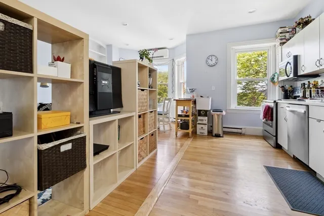 a view of a kitchen with furniture and wooden floor