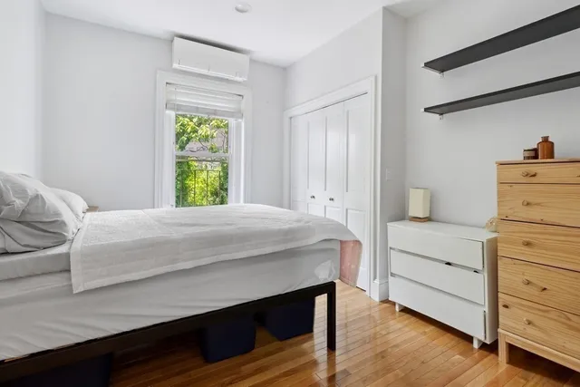 a bedroom with a bed and a window