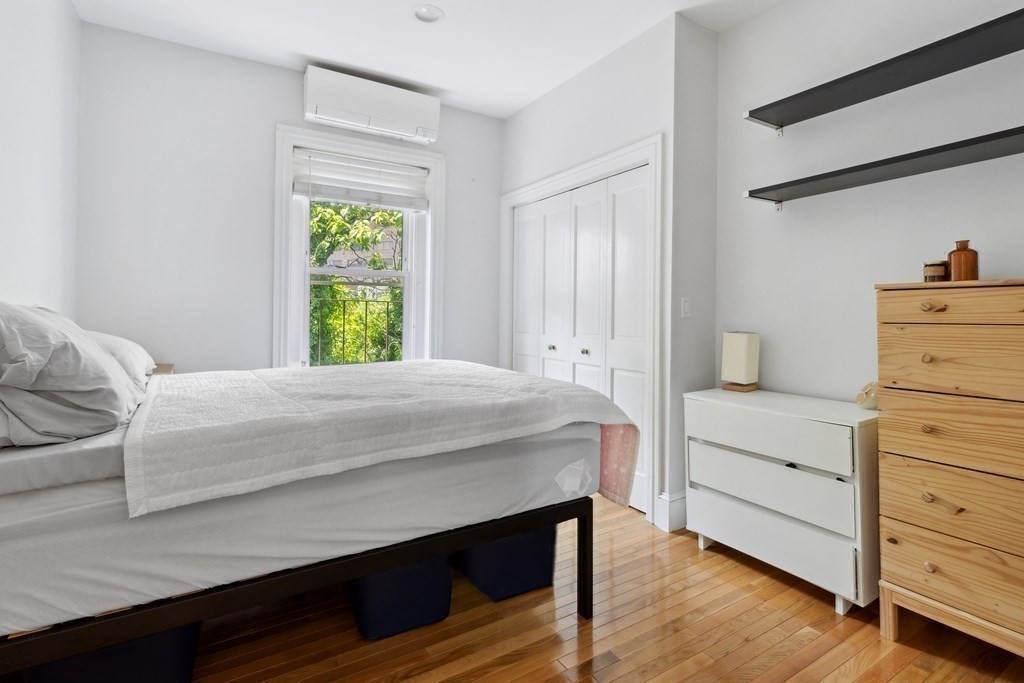 28 Beacon Street, Unit 3 Somerville, MA 02143 - Photo 8 of 11 a bedroom with a bed and a window