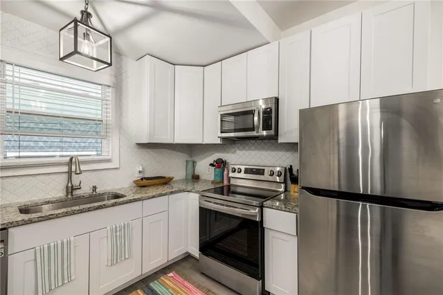 a view of a dining room with furniture and a potted plant