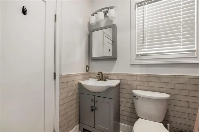 a living room with furniture a ceiling fan and a window