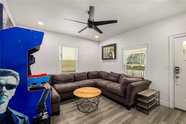 a kitchen with stainless steel appliances granite countertop a sink a stove a refrigerator cabinets and a window