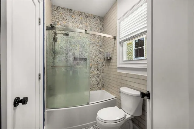 a view of backyard with small cabin and wooden fence