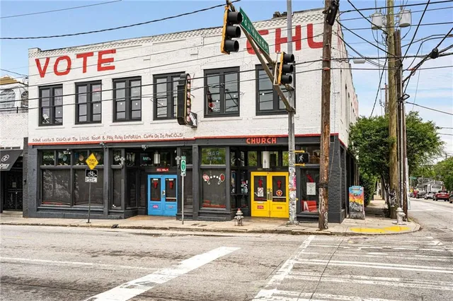 a view of a patio with couches table and chairs and potted plants