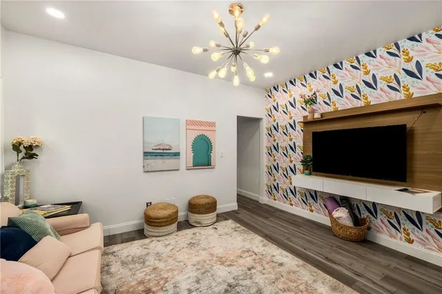 a kitchen with stainless steel appliances a sink a stove a microwave and cabinets