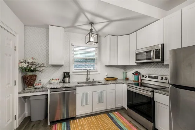 a kitchen with a sink a stove and cabinets