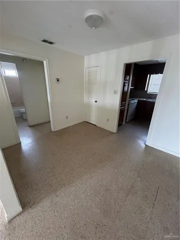 a view of an empty room with a closet