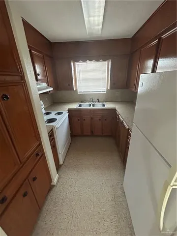 a kitchen with a refrigerator and window