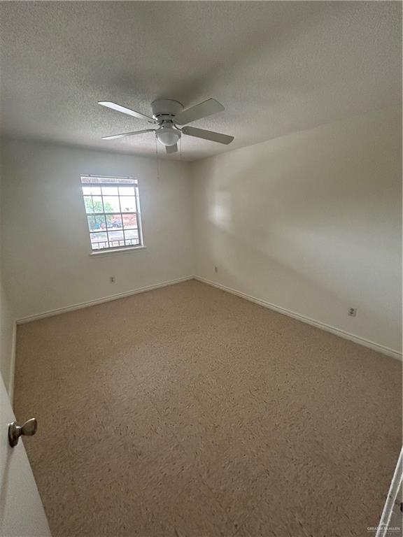 512 Gastel Circle, Unit 5 Edinburg, TX 78539 - Photo 6 of 10 en empty room with windows and ceiling fan