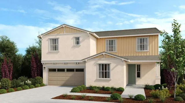 a view of a white house next to a yard