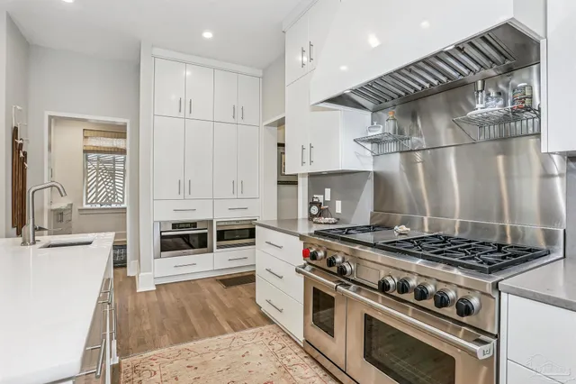 a view of a patio with a table and chairs under an umbrella