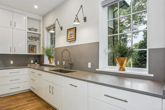 a kitchen with granite countertop white cabinets and white appliances