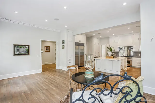 a kitchen with stainless steel appliances a white cabinets and a stove top oven
