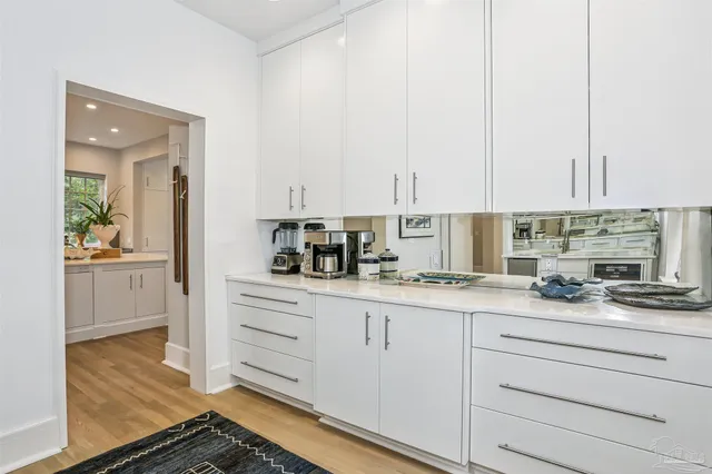 a living room with furniture a window and a chandelier