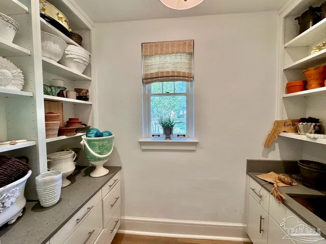 a living room with a floor to ceiling window and a table